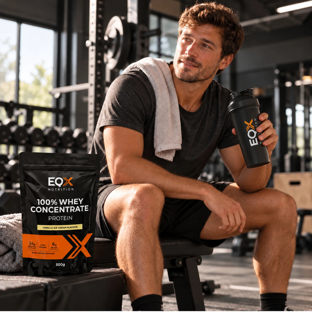 Man at the gym holding an EQX shaker next to a pack of 100% Whey Concentrate Vanilla Ice Cream.
